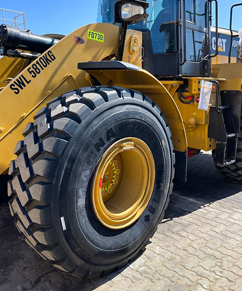 Close-up of a wheel loader fitted with MA01+ earthmoving tyres, providing superior grip and durability on rugged terrain.