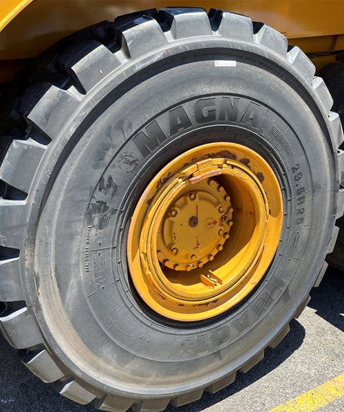 Close-up of a wheel loader fitted with MA01+ earthmoving tyres, providing superior grip and durability on rugged terrain.